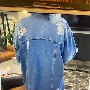 Denim long jacket with distress details.